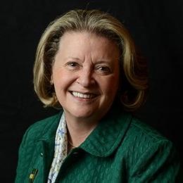 Person wearing green jacket smiling